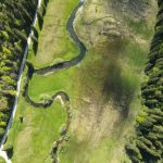 Stunning aerial view of Schliersee showcasing lush greenery, forest, and winding river.